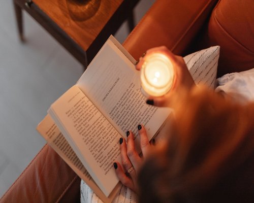 Reading a book with a warm desk lamp