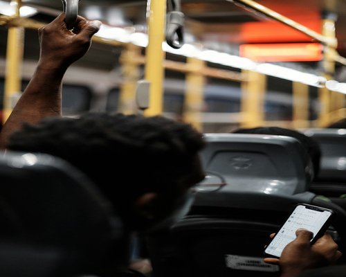 Person holding phone in public transport